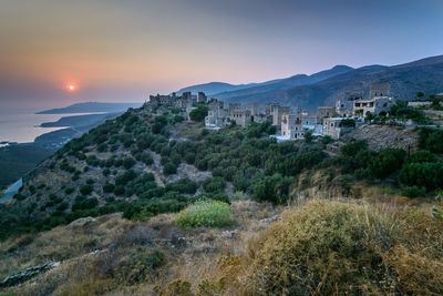 Scenic view of vathia historical village in mani, greece, against sky at sunset