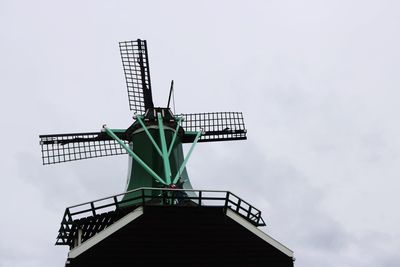 Low angle view of traditional windmill against sky