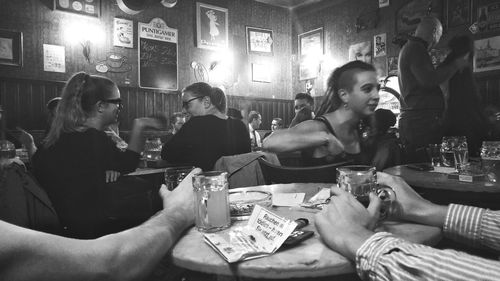 Midsection of people sitting in restaurant