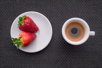 A cup of coffee with some strawberry on different background