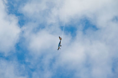 Low angle view of airplane flying in sky