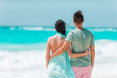 Rear view of couple standing on beach