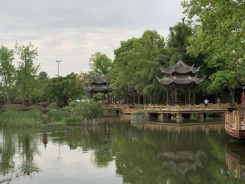 Scenic view of lake by building against sky