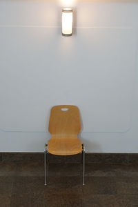 Empty chairs and table against wall at home