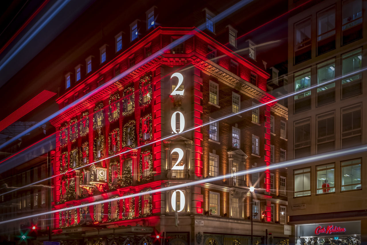 LOW ANGLE VIEW OF ILLUMINATED TEXT ON BUILDING