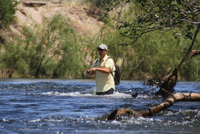 Portrait of young woman standing in lake