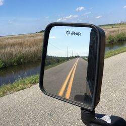 Reflection of road on side-view mirror of car