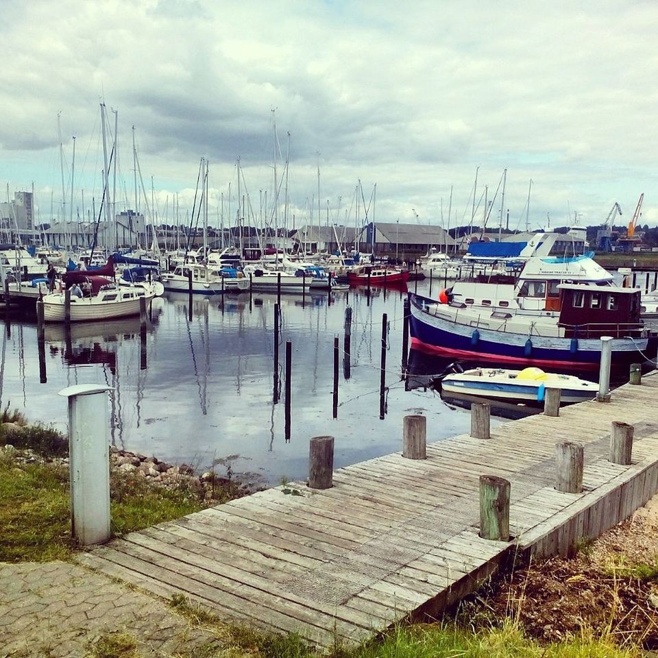 nautical vessel, moored, boat, transportation, water, mode of transport, sky, cloud - sky, harbor, cloudy, sea, cloud, lake, tranquility, mast, nature, pier, in a row, tranquil scene, outdoors