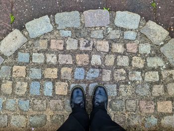 Low section of man standing on footpath