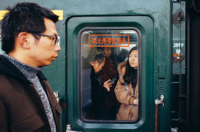 Side view of man in train
