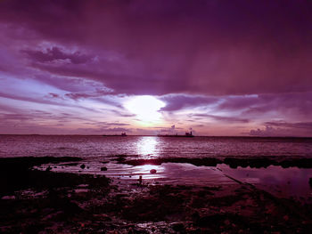 Scenic view of sea against dramatic sky