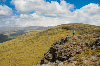 A hiker against a mountain background at ol doinyo lesatima in the aberdares, kenya