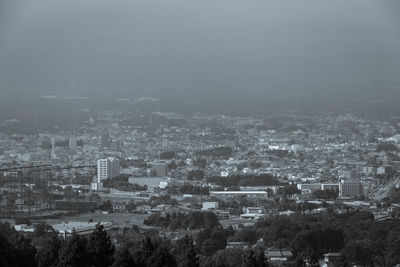 High angle view of buildings in city against sky