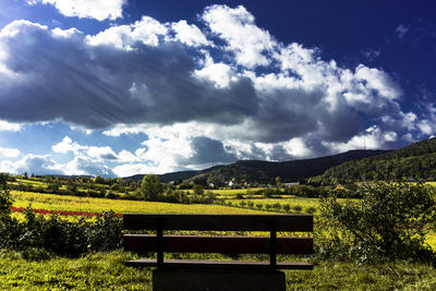 Scenic view of field and mountains against sky