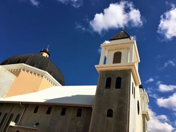 Low angle view of clock tower against sky