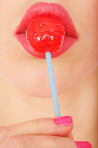 Close-up of woman eating lollipop