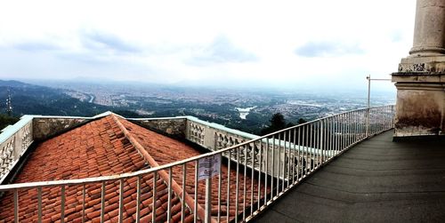 Cropped image of church overlooking cityscape against sky