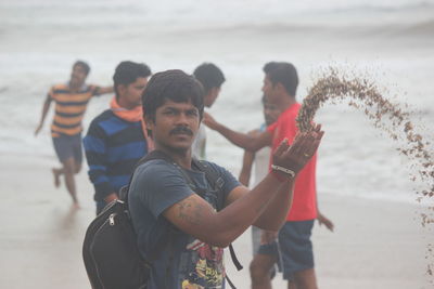 Friends standing on beach