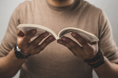 Midsection of woman reading book