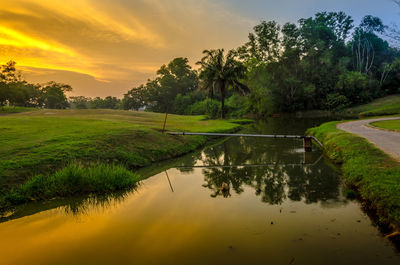 Scenic view of lake against sky during sunset