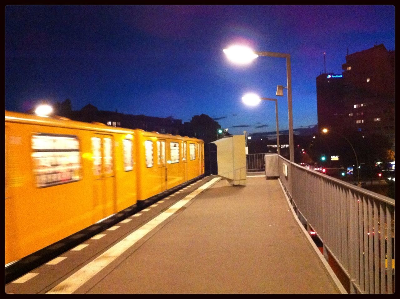 illuminated, night, street light, transportation, sky, the way forward, railroad track, building exterior, lighting equipment, built structure, architecture, diminishing perspective, city, transfer print, street, road, dusk, rail transportation, outdoors, vanishing point