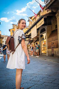 Smiling woman standing on street in city