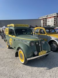 Cars on road against sky in city