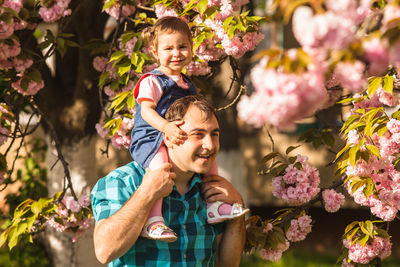 Father carrying daughter on shoulder