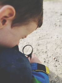 Close-up of boy holding magnifying glass