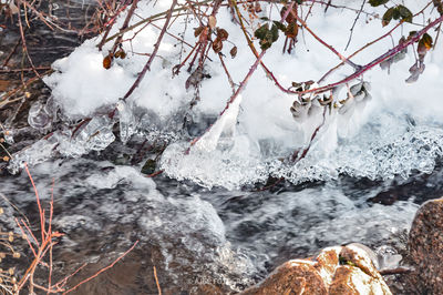 Frozen river amidst rocks in winter