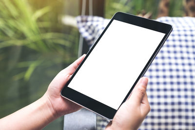 Cropped hands holding digital tablet