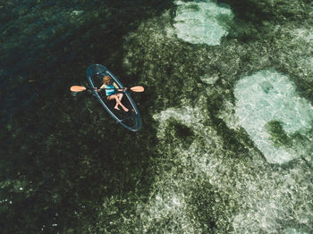 High angle view of woman on inflatable boat in sea