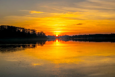 Scenic view of lake against orange sky