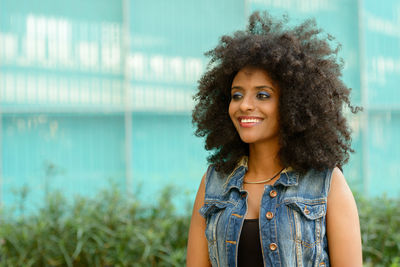 Portrait of smiling young woman standing outdoors