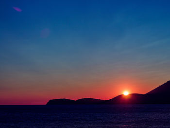 Scenic view of sea against romantic sky at sunset