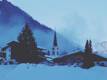 Houses against sky during winter