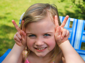 Close-up portrait of young woman against trees