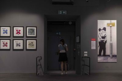 Rear view of man standing at entrance of museum