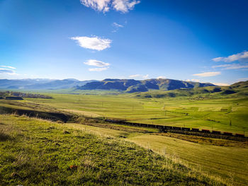 Scenic view of farm against sky