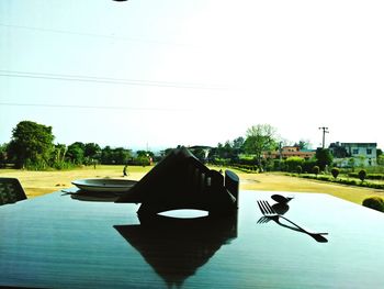 Silhouette of person on road against clear sky