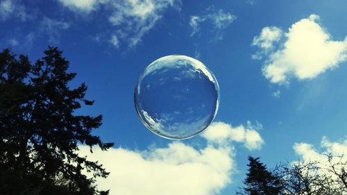 Low angle view of bubbles against sky