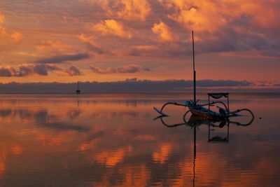 Scenic view of lake against orange sky