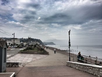 View of boats in sea against cloudy sky