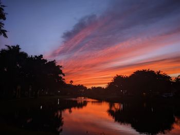 Scenic view of lake against romantic sky at sunset