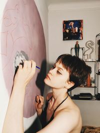Portrait of woman holding hands at home