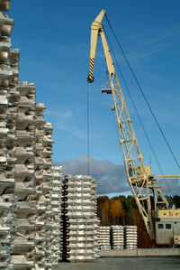 Low angle view of stack against blue sky