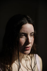 Portrait of a beautiful young woman over black background