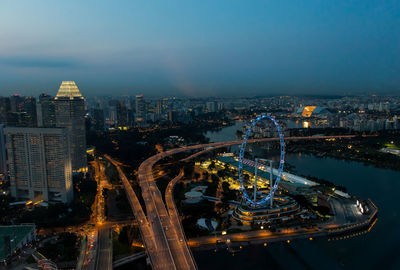 High angle view of city lit up at night