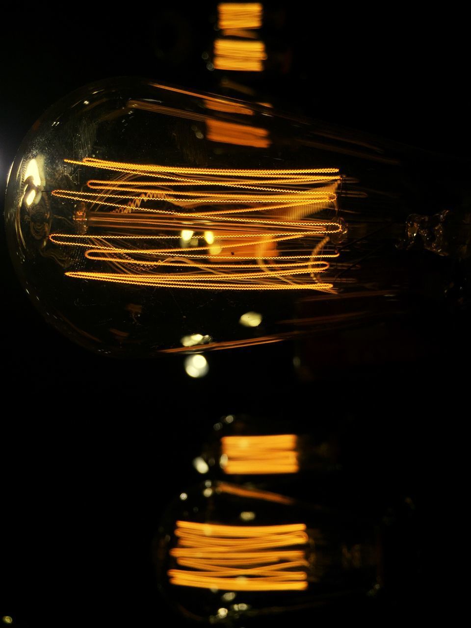 CLOSE-UP OF ILLUMINATED LIGHT BULBS