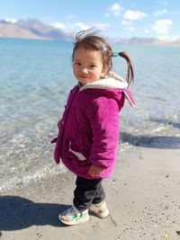 Portrait of girl standing at lakeshore